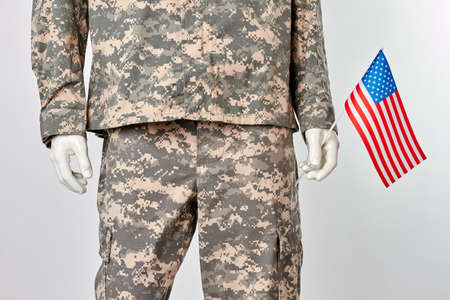Patriotic us soldier concept. Mannequin in military uniform with american flag. White isolated...