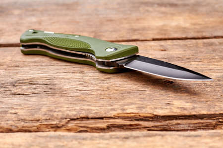 Jacknife on wood. Close up. Wooden desk table surface.の写真素材