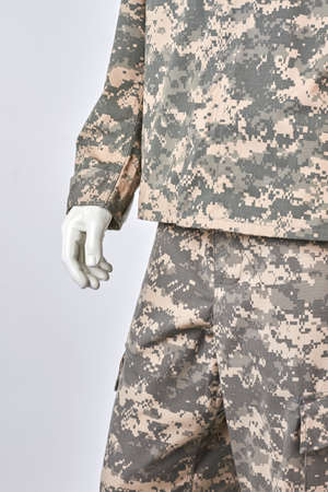 Right mannequins hand in soldiers uniform. Close up, cropped image. White isolated background.の写真素材
