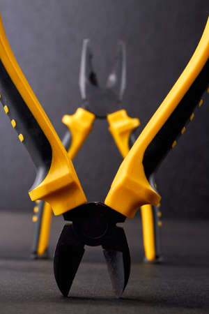 Close up pliers on dark background. Hand tool for repair or construction.の写真素材