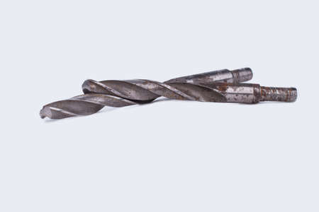 Rusty drill bits on white background. Old spiral tool for perforator. Instrument for drilling...