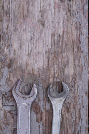 Steel wrenches and copy space. Stainless steel tools on rustic wooden background. Top view with text space.の写真素材