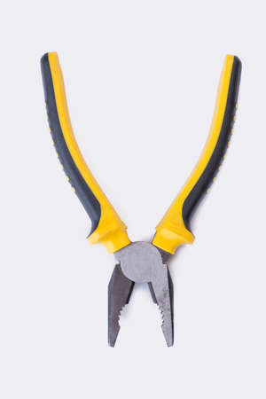 Open pilers on white background. Tool with black and yellow handle. Top view with copy space.の写真素材