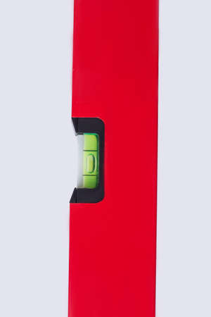 Close up of spirit level on white background. Building tool, vertical image.