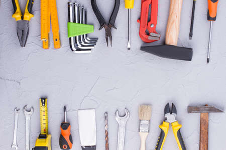 Background of construction tools with text space. Mechanic and carpenter tools on gray background...
