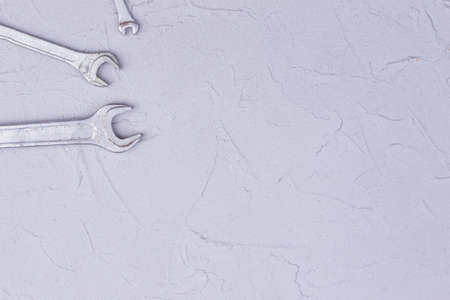 Set of spanners with copy space. Stainless steel three wrench or spanners on gray background. Space...