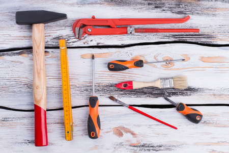 Different construction tools on wooden background. Group of various instruments for repair on wooden boards.の写真素材