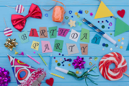Happy Birthday background with party supplies. Birthday decor on blue wooden background. Birthday decoration ideas.の写真素材