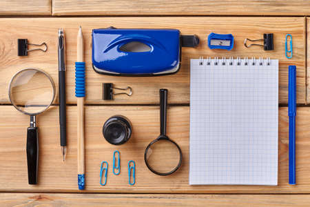 Set of office accessories with blank notebook. Flat lay of different office supplies on wooden table.の写真素材