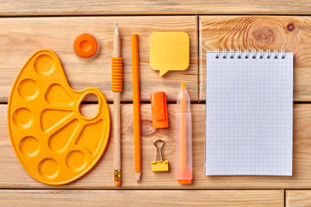 Blank notebook and color school items. Stationery supplies and empty paper notepad. Education and...