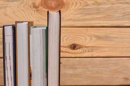 Books on wooden background and copy space. Science and education concept.の写真素材
