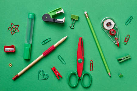 Colorful school supplies on green background. Top view, flat lay. Back to school.の写真素材