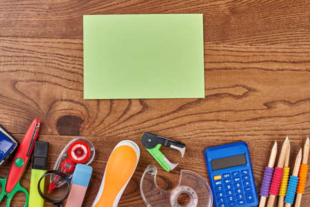 Flat lay with school accessories. Variety of school supplies and blank paper card. Back to school, education background.の写真素材