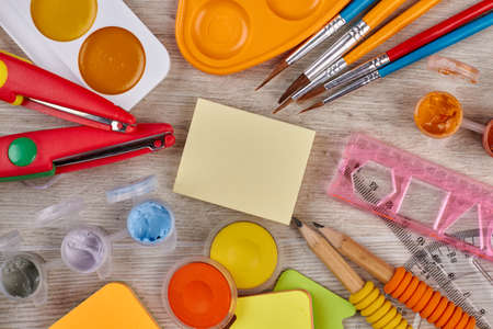 School supplies on wooden background. Art concept with painters palette and paint brush.の写真素材
