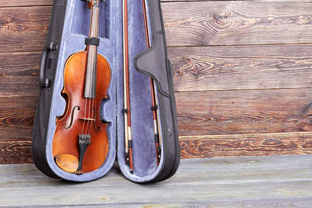 Violin in case and copy space. Vintage musical instrument and space text. Create melody of soul.の写真素材