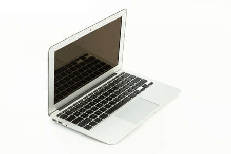 Opened laptop computer on white background. Silver notebook with blank screen. Contemporary wireless...