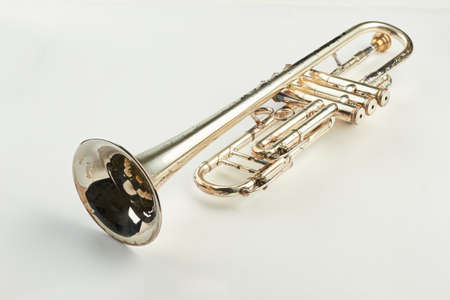 Old orchestra instrument on light background. Rusty trumpet instrument with clipping path.の写真素材