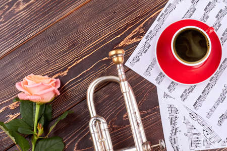 Trumpet, musical notes and cup. Classical music background. Music still life.の写真素材