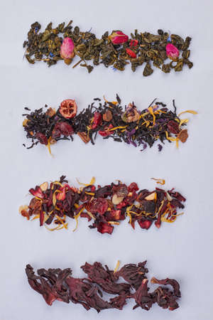 Four types of dried tea on white background. Rows of assorted dry tea, vertical image.の写真素材