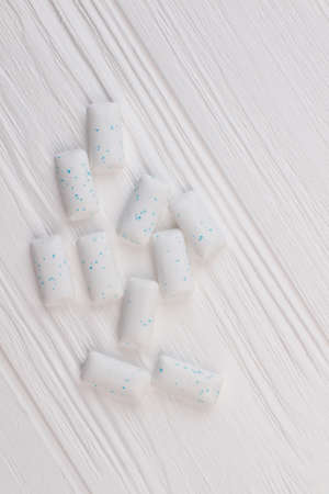 Heap of chewing gums on white wooden background. Chewing gums for keeping your teeth healthy.の写真素材