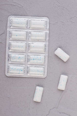 Pack of chewing gums on gray background. Chewing gum in blister, top view. Refresh your breath.の写真素材