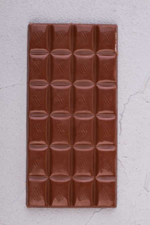 Bar of chocolate, top view. Milk chocolate bar. Unhealthy food concept.の写真素材