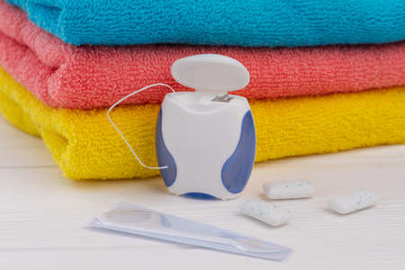 Dental hygiene background. Stack of clean towels, dental floss, toothpick and chewing gums. Take care of your teeth.の写真素材
