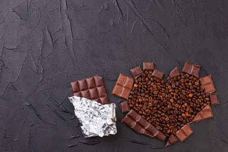 Chocolate bar and heart made from coffee beans. Heart shaped coffee beans and chocolate bar wrapped...