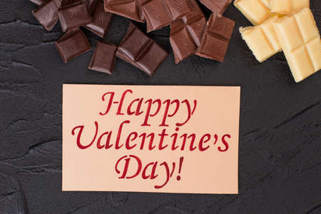 Happy Valentines Day background. Chocolate bars and card with handwritten inscription Happy Valentines Day. Congratulate your loved one.の写真素材