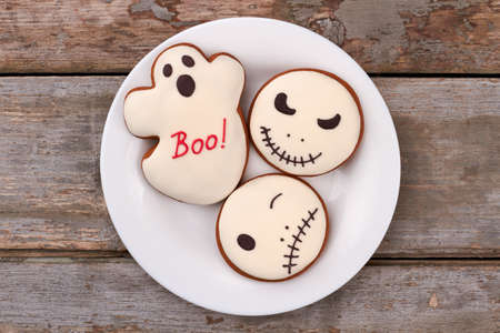 Halloween decorated cookies on plate. Ghost and Jack Skellington gingerbread cookies. Quick and easy Halloween treats.の写真素材