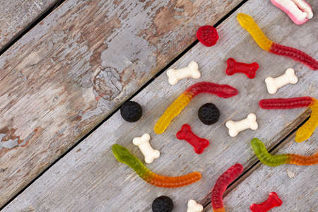 Halloween colorful candies decor on wooden background. Halloween background with gummy sweets. Halloween holiday theme.の写真素材
