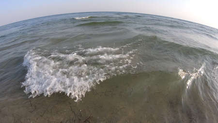 Waving sea at blue sky background. Close up of sea waves on the beach on a summer day. Sound of...
