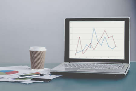 Office workplace. Laptop with exchange charts. Working process.