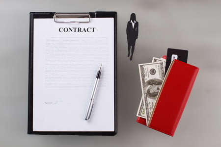 Contract with signature. Businesswoman knocked out a profitable contract. Business concept.の写真素材