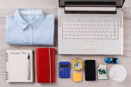 Laptop, personal things and wallet. Attributes of successful lady.の写真素材