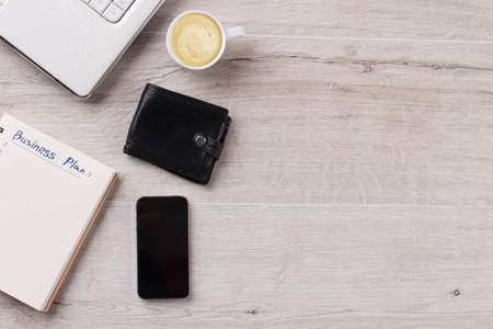 Laptop, notepad and cappuccino. Business cases can wait. Minimalism concept.