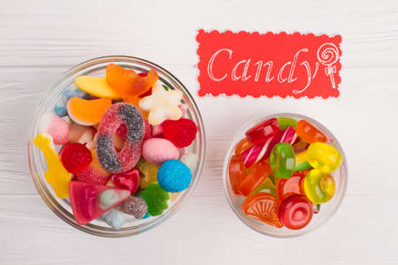 Colorful candies in glass bowls. Two glass bowl filled with bright colored sweets. Tasty treats for...