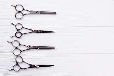 Steel hair dresser scissors for barber shop. Group of salon shears on white background. Space for...