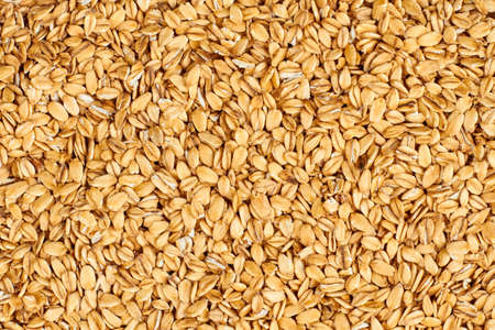 Oat flakes background. Oatmeal flakes texture. Food concept.