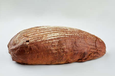 Loaf of bread and copy space. Fresh rye bread isolated on white background.の写真素材