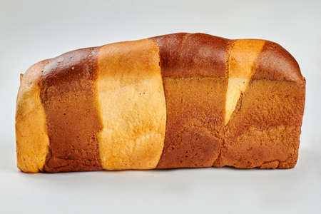 Colorful square bread on white background. Freshly baked two color bread.の写真素材