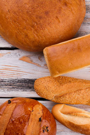 Various bread on wooden background, top view. Homemade organic bread and copy space.