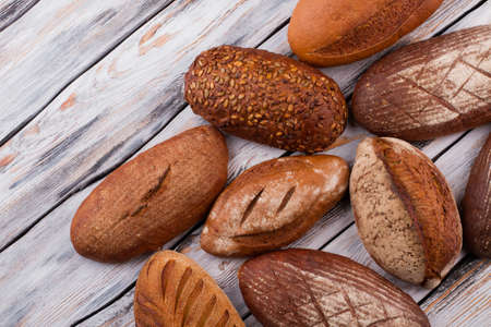 Organic healthy bread on wooden background. Artisan bread loaves. Homemade bread recipe.
