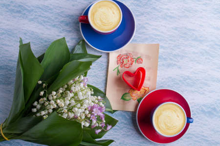 Wife or girfriend love concept. Lilies of the valley bouquet and cups of coffee.の写真素材