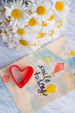 Happy lovely day concept. Bouquet of chamomile flowers and watercolor painting with text.の写真素材