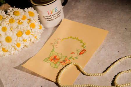 Romantic, art and morning concept. Still life, flowers painting, pearl bead necklce and cup of coffee.の写真素材