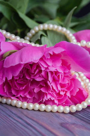 Bead pearl necklace with peony flower. Close-up.の写真素材