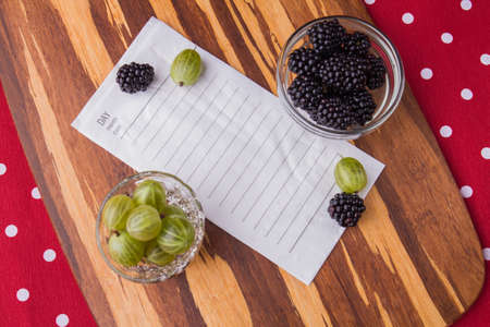 Ingridients for salad and recipe. Cherry-plums and blackberries in a glassware