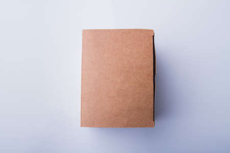 Cardboard box plain macro surface. Closed package conatiner, smooth cover. Isolated on white.の写真素材