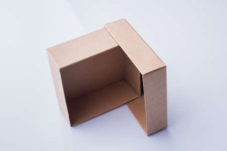 Two box pieces are standing on ribs making angle. Isolated on white, perspective view.の写真素材